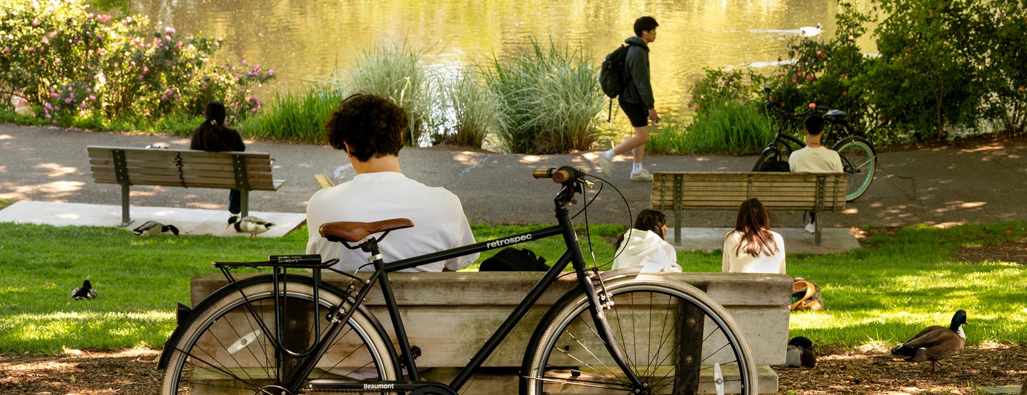 Student sitting on bench near his bike